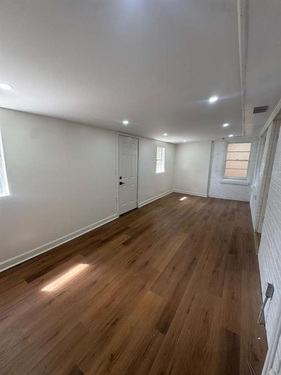 3005 Belvedere Lane Decatur, GA 30032 - Photo 6 of 16 an empty room with wooden floor and windows
