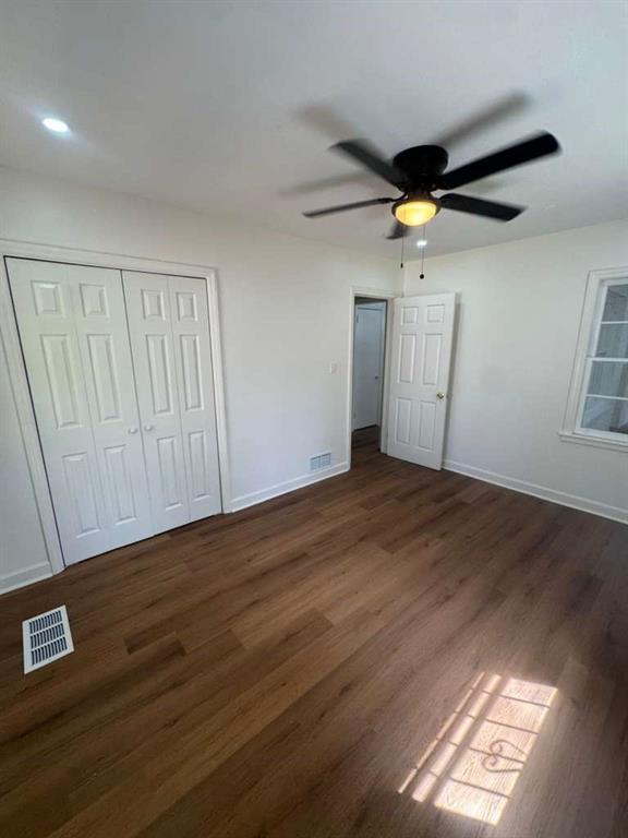 3005 Belvedere Lane Decatur, GA 30032 - Photo 9 of 16 an empty room with wooden floor and windows