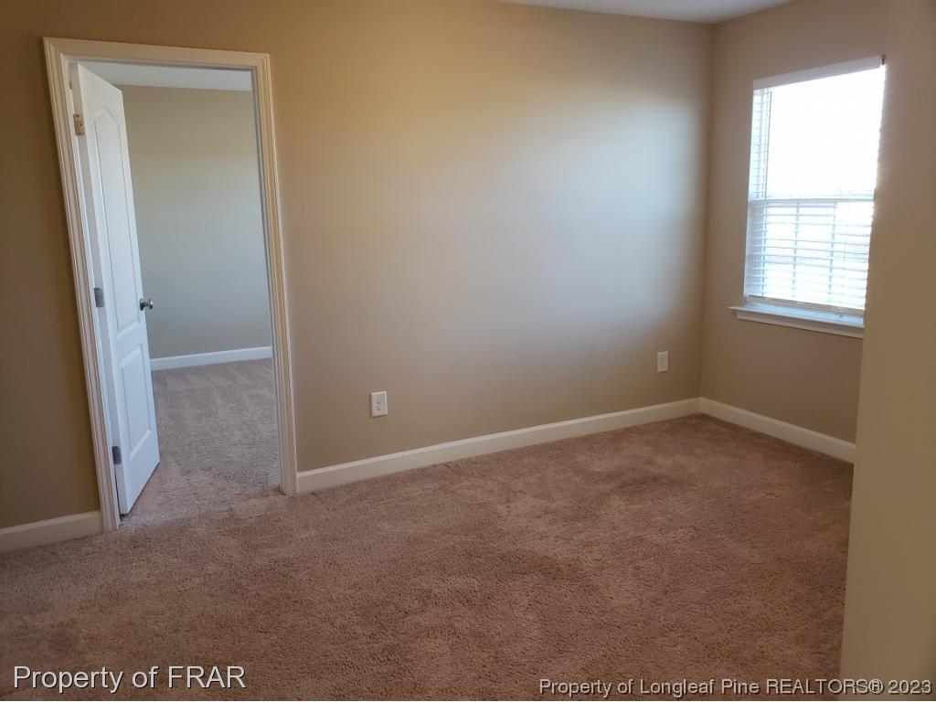 211 Rainmaker Street Linden, NC 28356 - Photo 11 of 34 an empty room with windows and closet