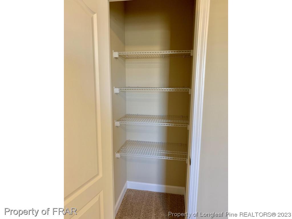 211 Rainmaker Street Linden, NC 28356 - Photo 13 of 34 a walk in closet with wooden floor