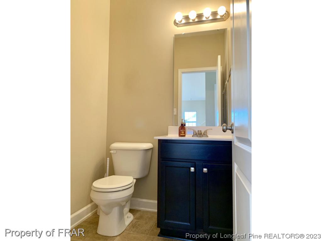 211 Rainmaker Street Linden, NC 28356 - Photo 14 of 34 a bathroom with a toilet a sink and mirror