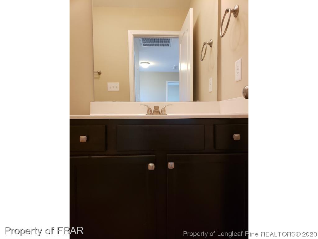 211 Rainmaker Street Linden, NC 28356 - Photo 16 of 34 a bathroom with a sink and a mirror