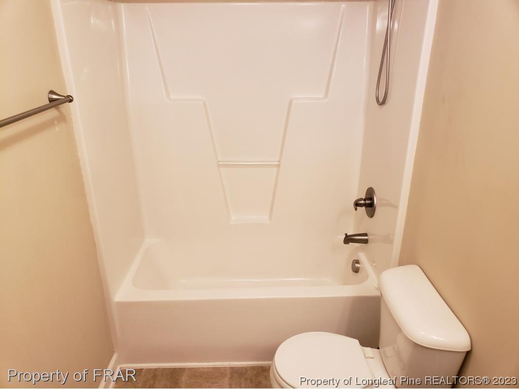 211 Rainmaker Street Linden, NC 28356 - Photo 17 of 34 a bathroom with a toilet and a bathtub