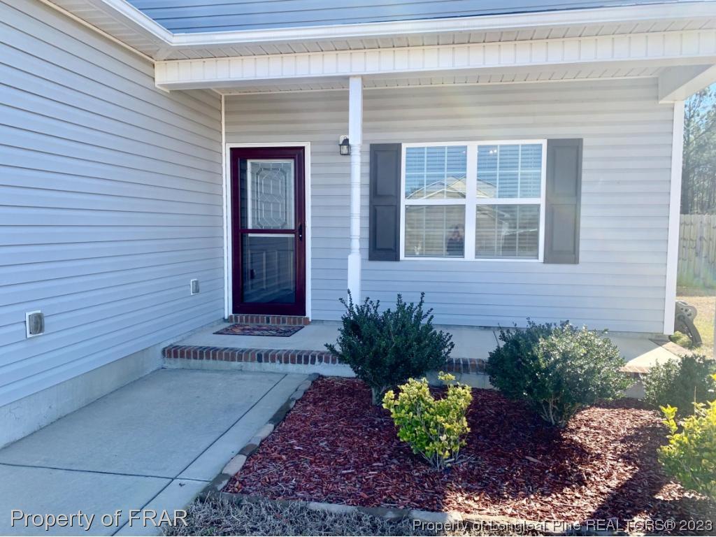 211 Rainmaker Street Linden, NC 28356 - Photo 2 of 34 a front view of a house with a yard