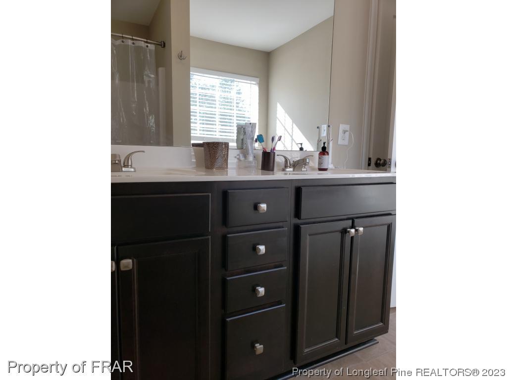 211 Rainmaker Street Linden, NC 28356 - Photo 25 of 34 a bathroom with a sink vanity and mirror