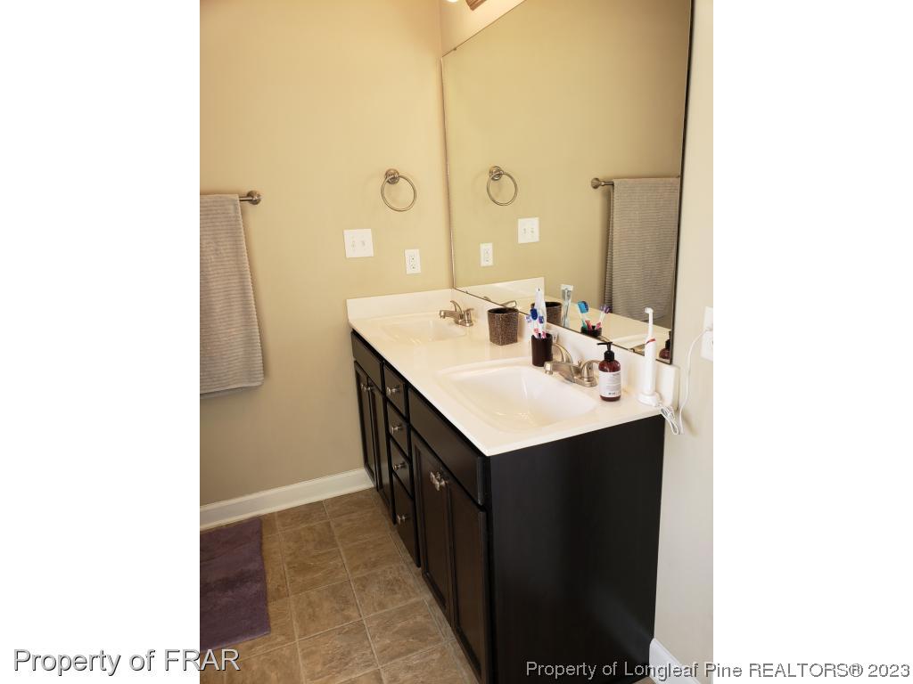 211 Rainmaker Street Linden, NC 28356 - Photo 26 of 34 a kitchen with a sink and a mirror