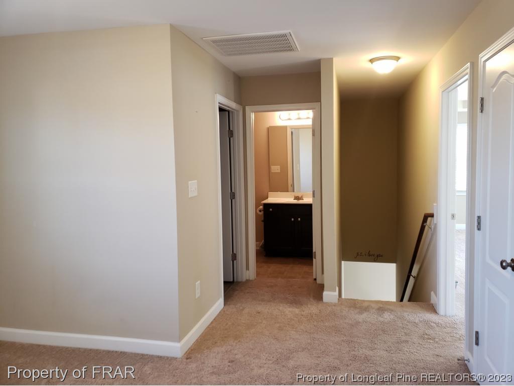 211 Rainmaker Street Linden, NC 28356 - Photo 29 of 34 a view of a hallway and a room with a bathroom