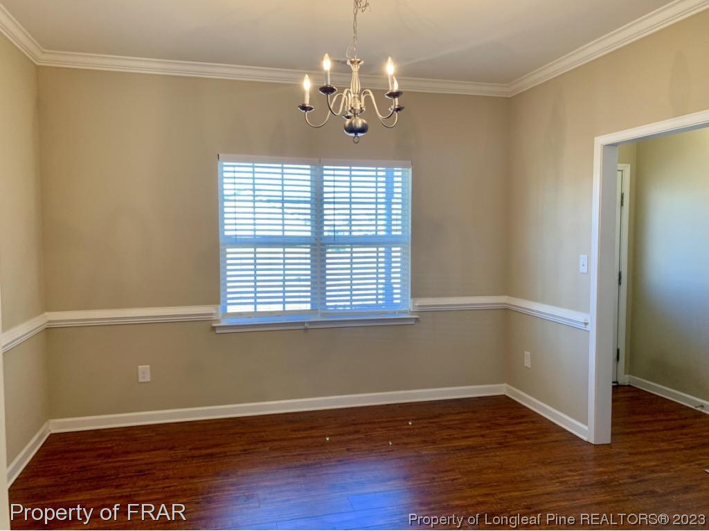211 Rainmaker Street Linden, NC 28356 - Photo 4 of 34 a view of a room with wooden floor and chandelier