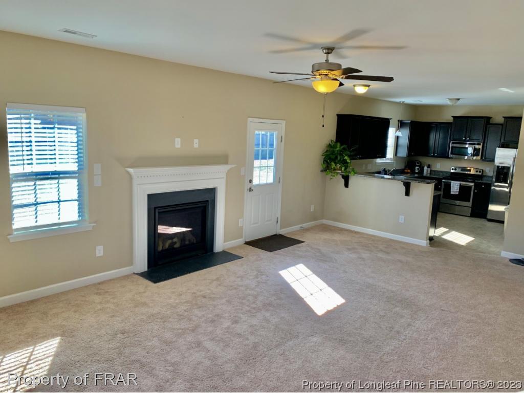 211 Rainmaker Street Linden, NC 28356 - Photo 5 of 34 a view of an empty room with a window and a fireplace