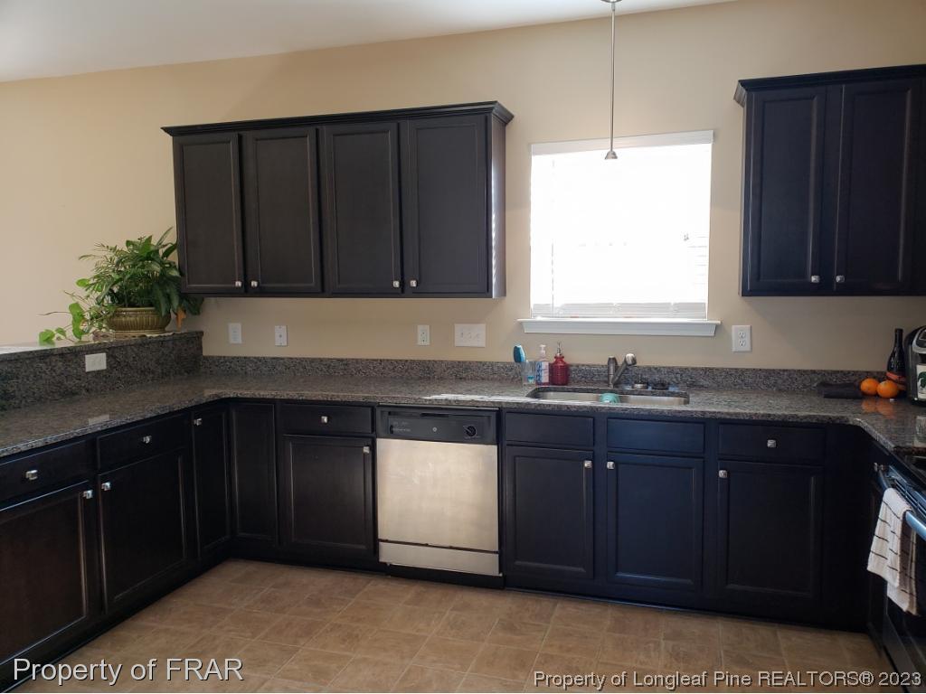 211 Rainmaker Street Linden, NC 28356 - Photo 9 of 34 a kitchen with granite countertop cabinets and window