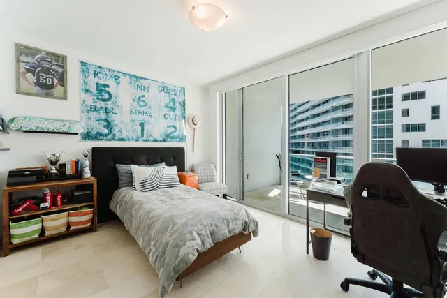 a bedroom with a bed and a desk