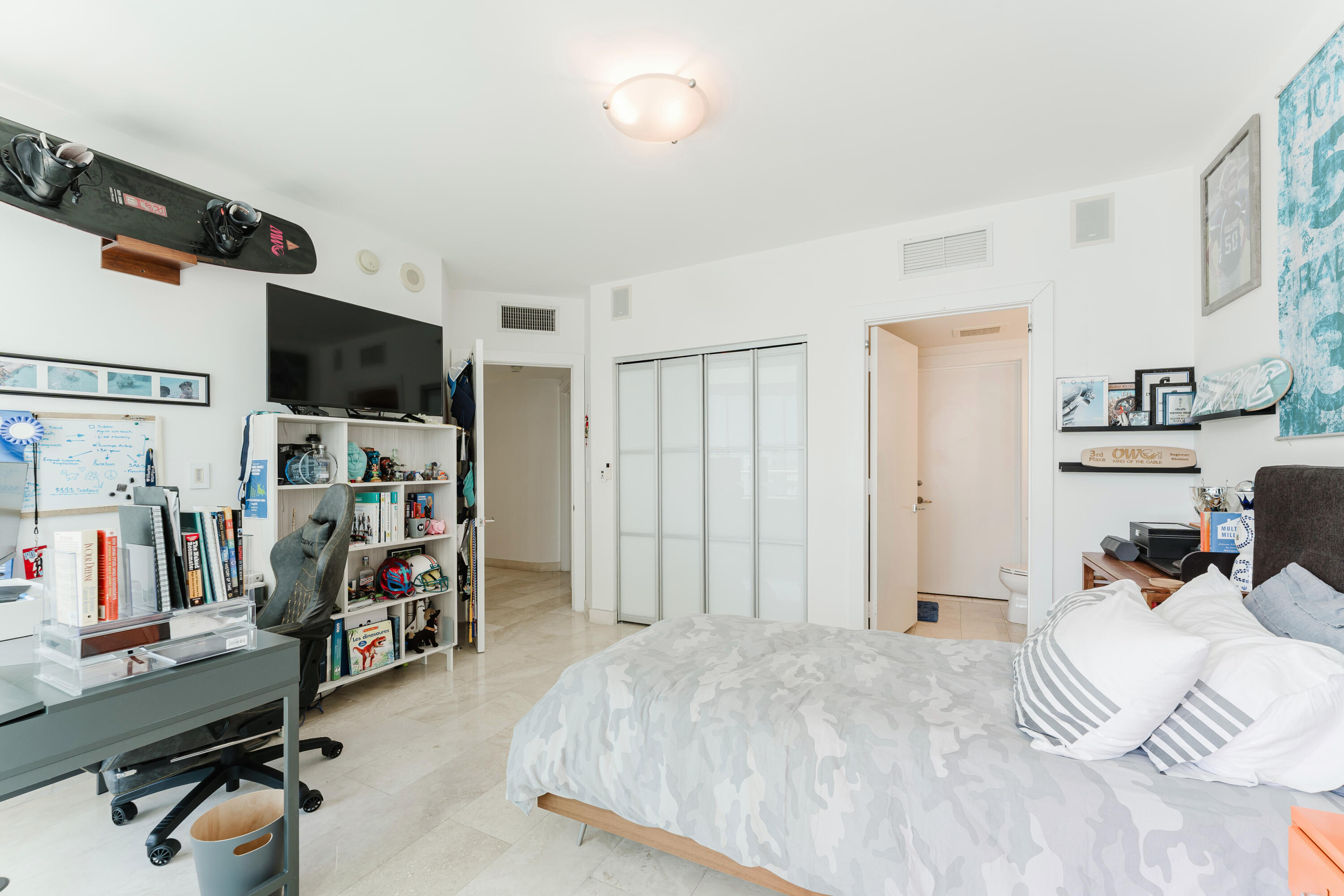 1331 Brickell Bay Drive, Unit 2805 Miami, FL 33131 - Photo 15 of 30 a bedroom with a bed and a flat screen tv