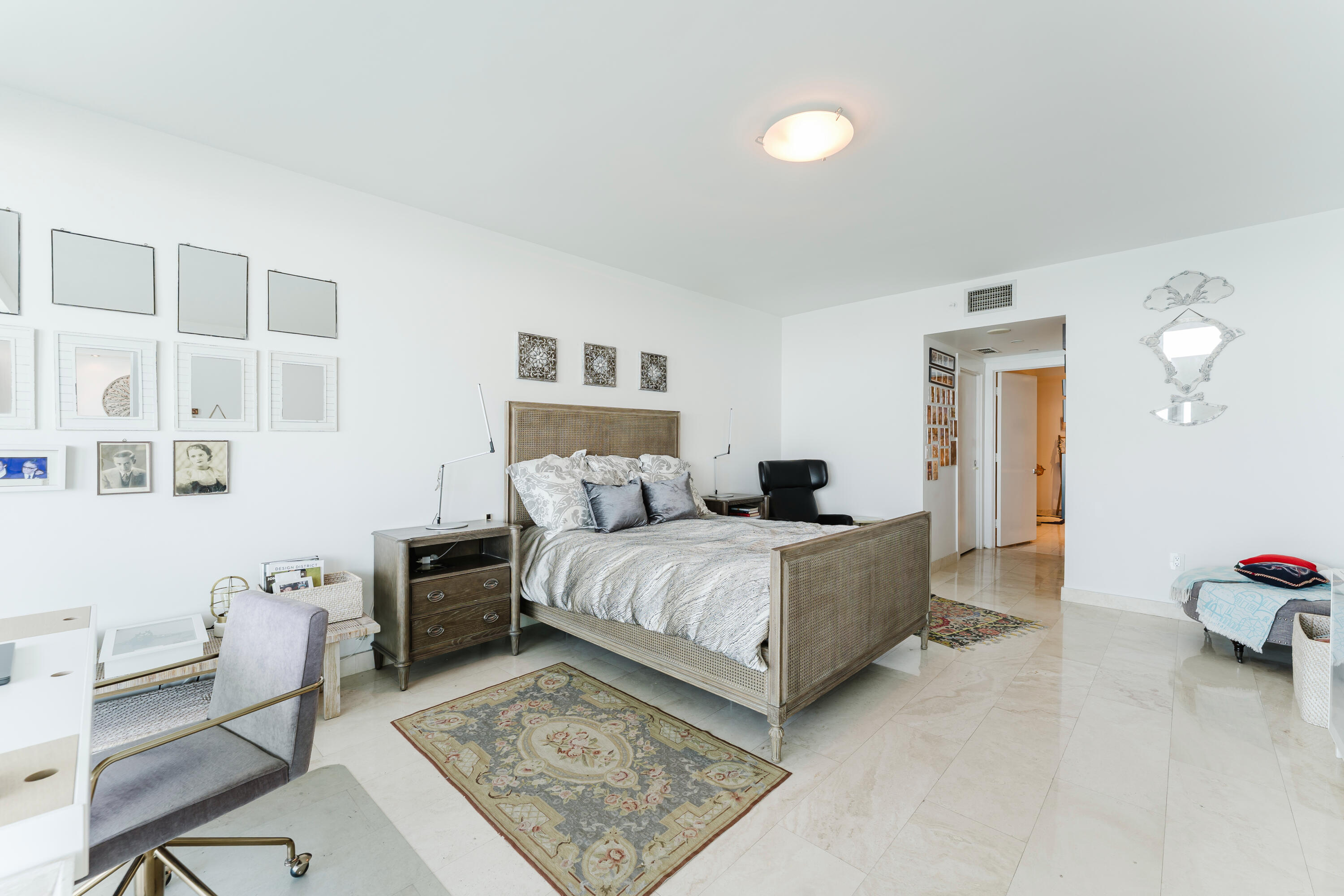 1331 Brickell Bay Drive, Unit 2805 Miami, FL 33131 - Photo 16 of 30 a spacious bedroom with a bed and a desk in it