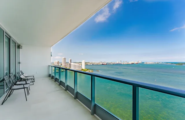 a view of a terrace with lawn chairs