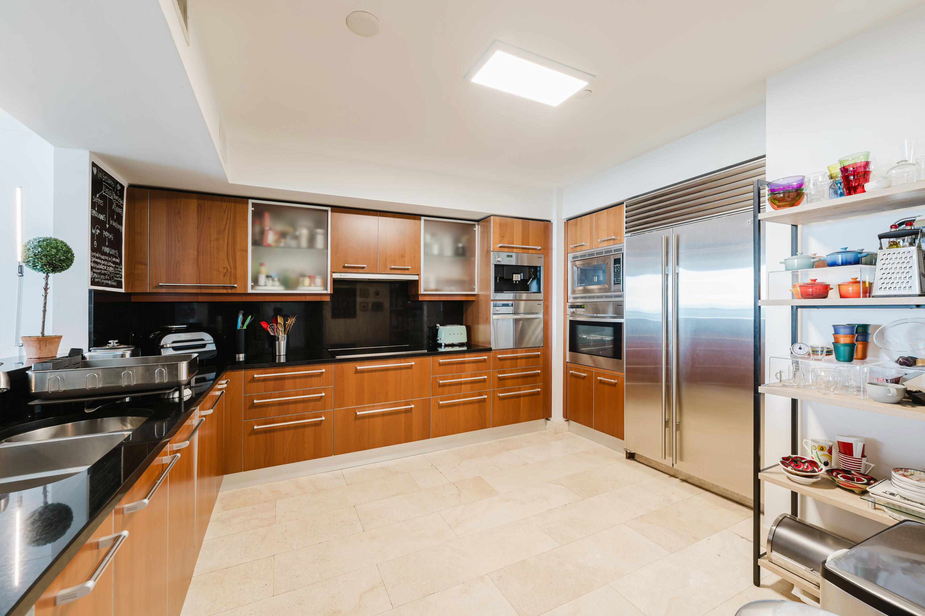 1331 Brickell Bay Drive, Unit 2805 Miami, FL 33131 - Photo 5 of 30 a large kitchen with stainless steel appliances granite countertop a refrigerator and a stove top oven