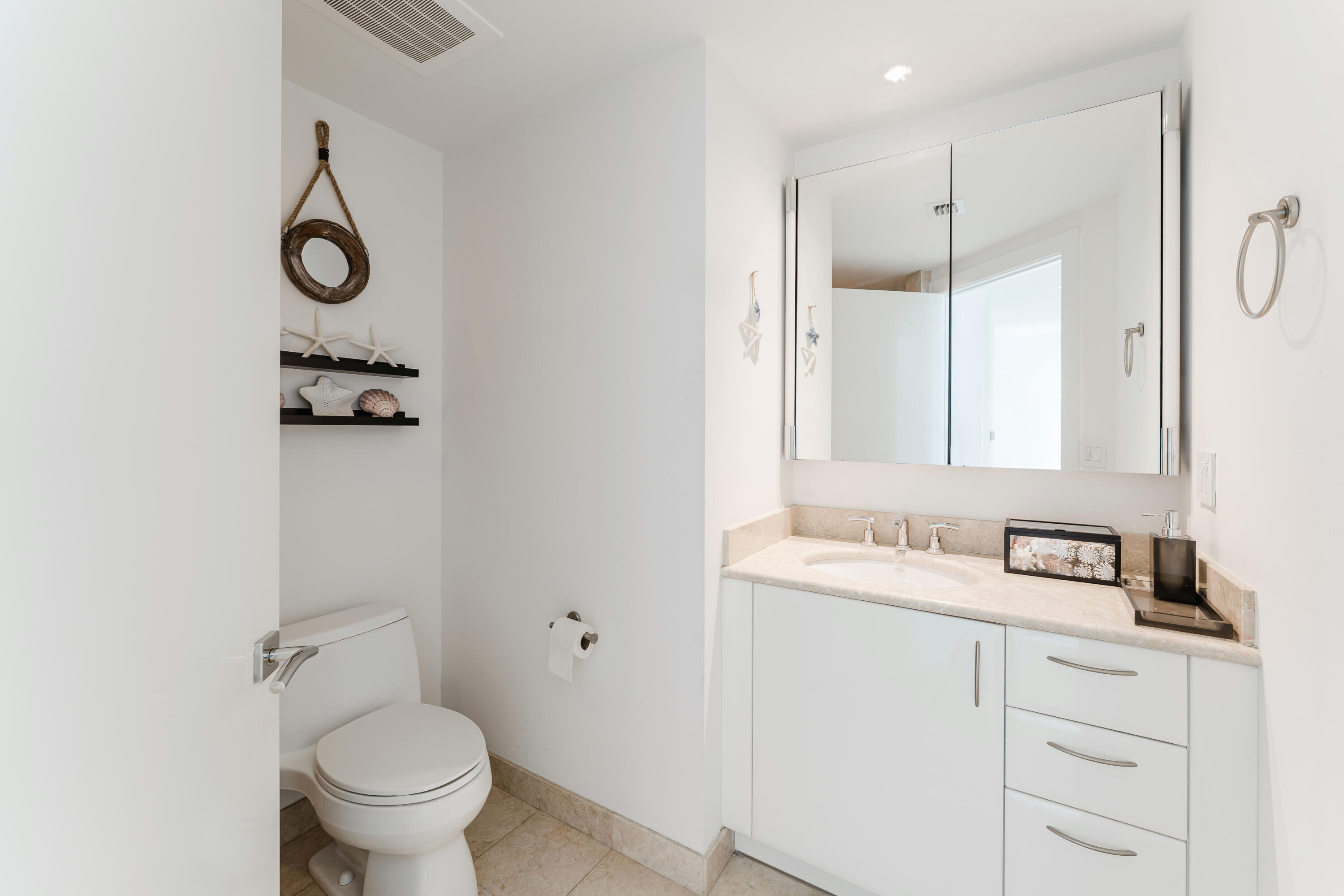 1331 Brickell Bay Drive, Unit 2805 Miami, FL 33131 - Photo 8 of 30 a bathroom with a granite countertop sink toilet and a mirror