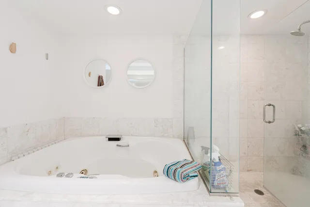 a bathroom with a tub and a shower