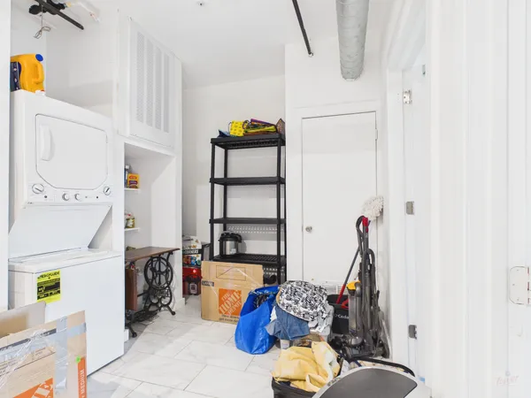 a workspace with furniture a rug and white walls