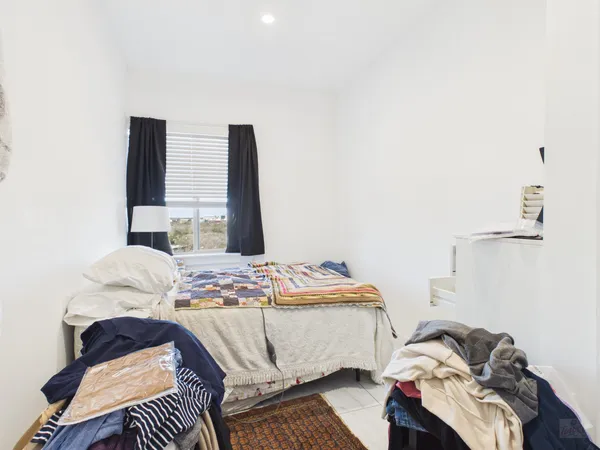 a bedroom with a bed and dresser