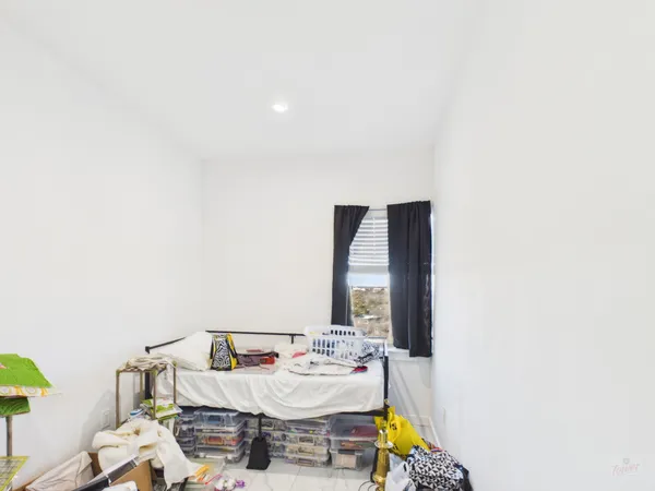 a living room with furniture and a mirror