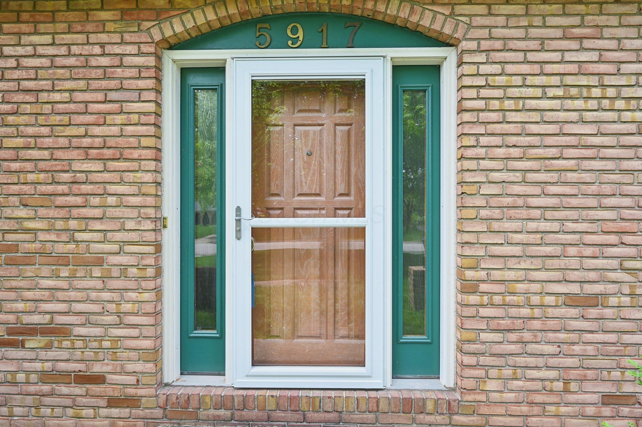 5917 Rocky Rill Road Columbus, OH 43235 - Photo 5 of 47 Front Door – Detail View
Updated storm door and transom windows frame the entryway, with house number clearly displayed above.