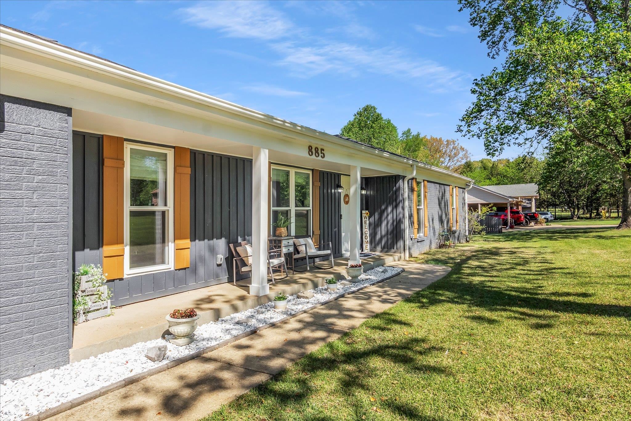 885 Rebel Road Piperton, TN 38017 - Photo 1 of 30 Rear view of property featuring a porch, a lawn, board and batten siding, and brick siding