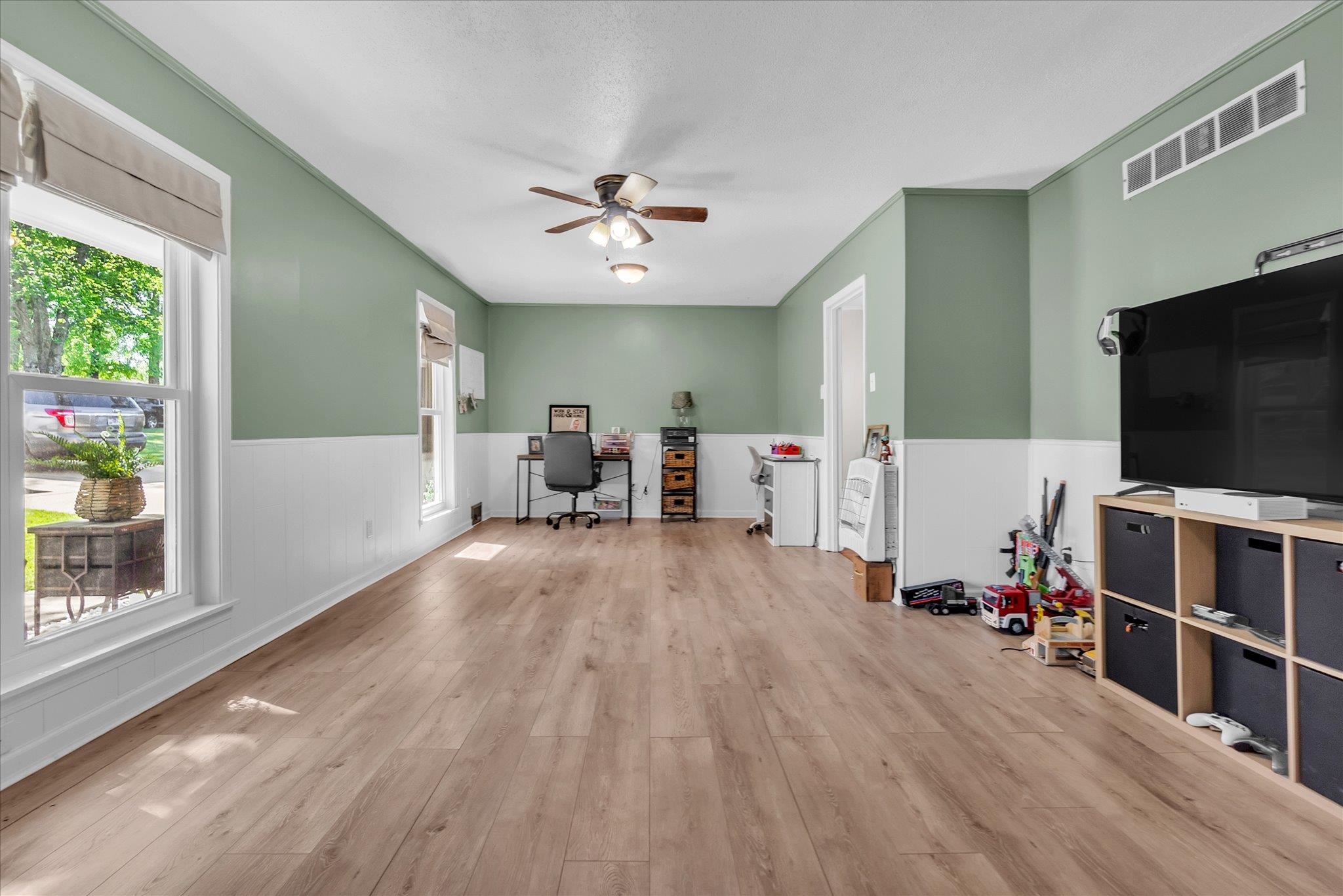 885 Rebel Road Piperton, TN 38017 - Photo 4 of 30 Home office with ceiling fan, light wood-style floors, and a wainscoted wall