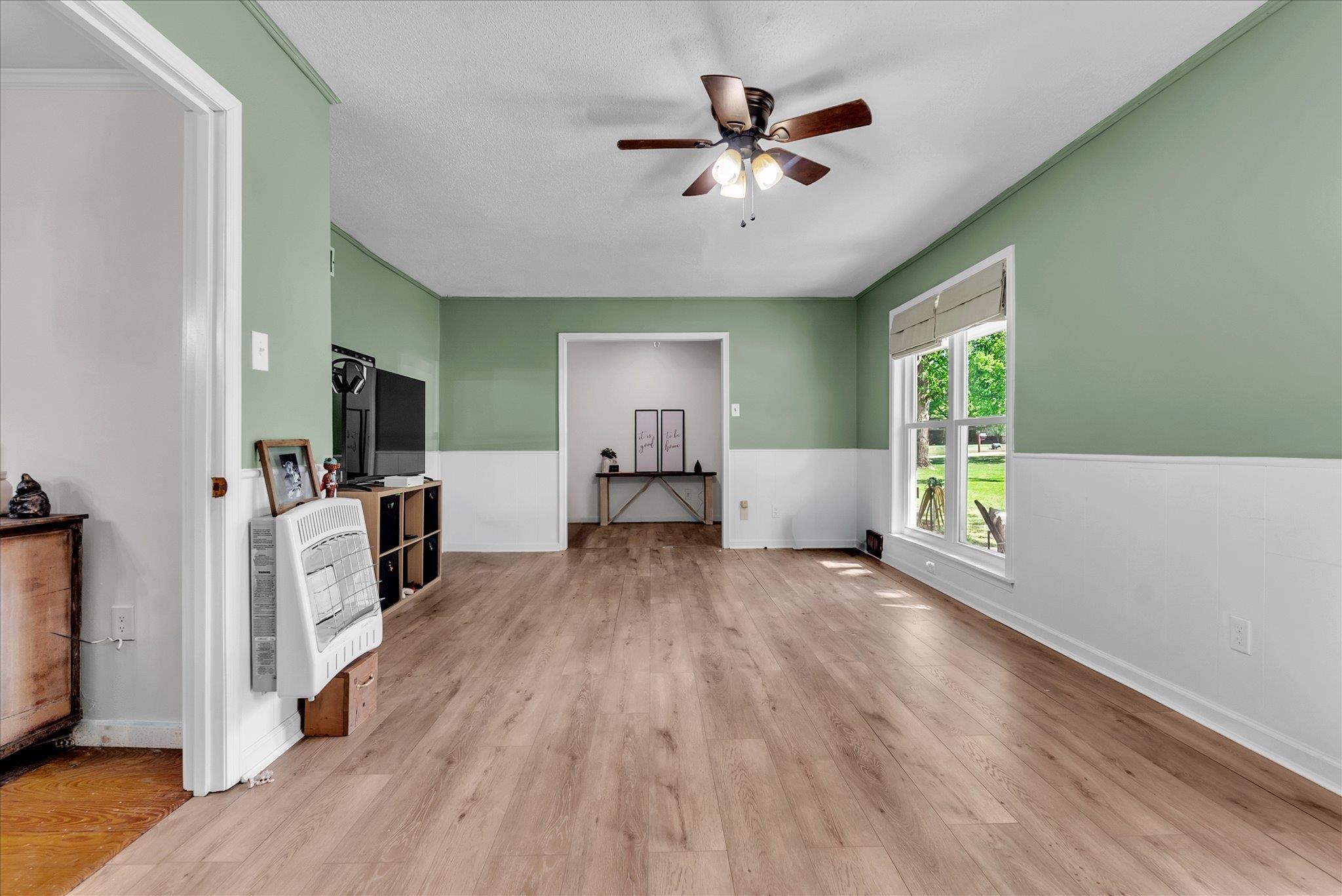 885 Rebel Road Piperton, TN 38017 - Photo 5 of 30 Living area featuring heating unit, light wood-style flooring, and a ceiling fan