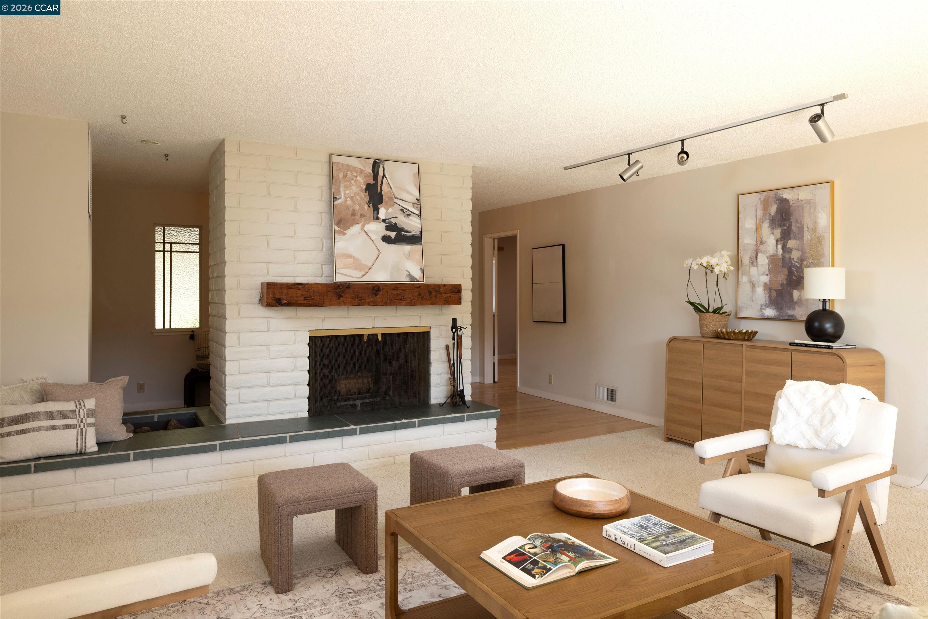 12 Marquard Road Carmel Valley, CA 93924 - Photo 10 of 36 a living room with furniture a fireplace and a flat screen tv