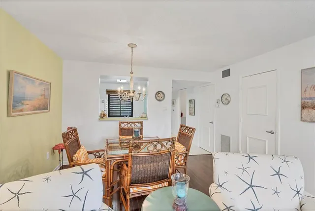 a view of a dining room with furniture wooden floor and a chandelier