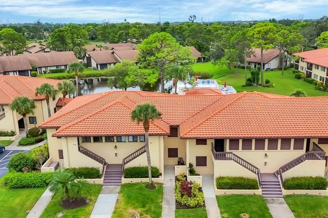 an aerial view of a house with garden space and a street view