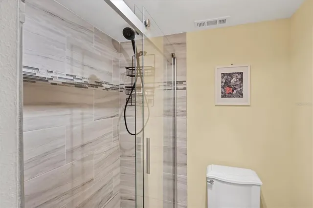 an aerial view of a city with lots of residential buildings ocean and mountain view in back