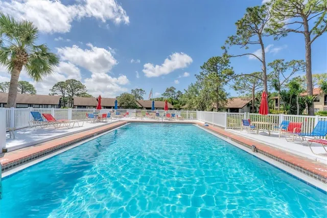 a view of a house with a yard patio and a fire pit