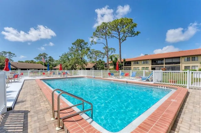 a kitchen with stainless steel appliances kitchen island a table and chairs