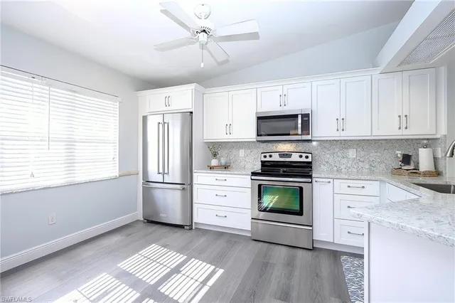 a kitchen with stainless steel appliances a stove a sink and a refrigerator