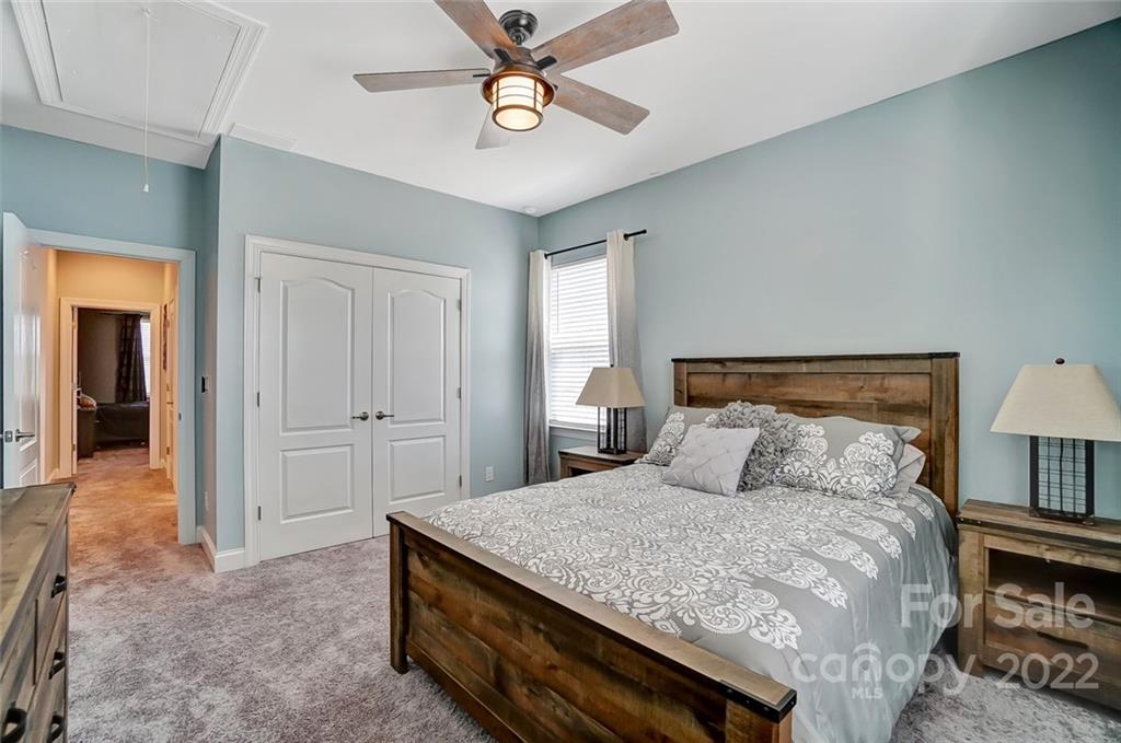 1014 Capwalk Road Concord, NC 28027 - Photo 21 of 31 a bedroom with a bed and a lamp on dresser