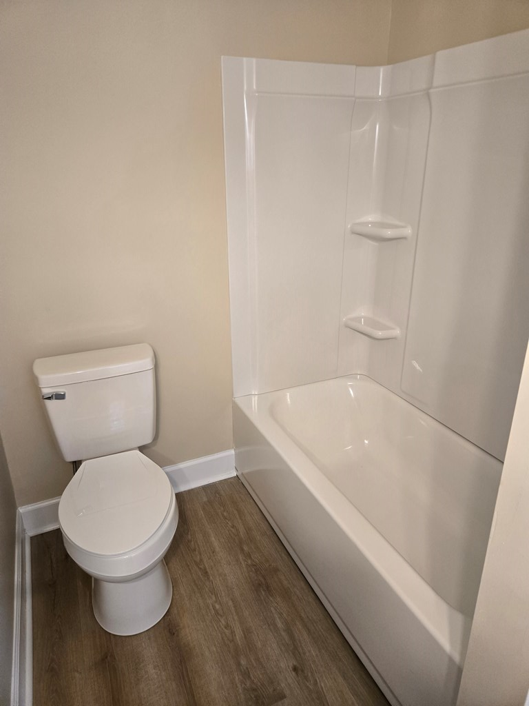 9 Linden Point, Unit B Columbus, GA 31904 - Photo 14 of 18 a white toilet sitting next to a bath tub