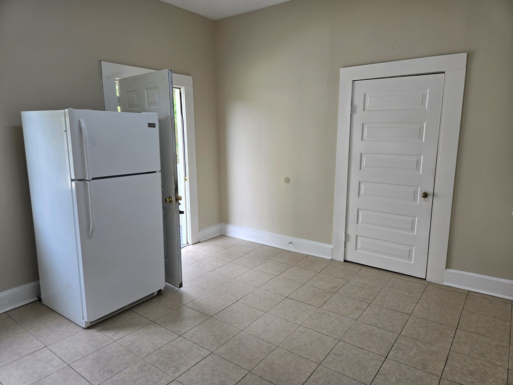 9 Linden Point, Unit B Columbus, GA 31904 - Photo 9 of 18 a view of a refrigerator in kitchen and white cabinets