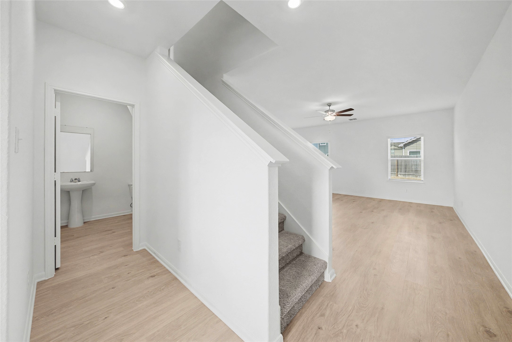 237 Fairlawn Way Maxwell, TX 78656 - Photo 2 of 12 The entryway features light wood flooring, a carpeted staircase, and leads to a bright living area with a ceiling fan and windows