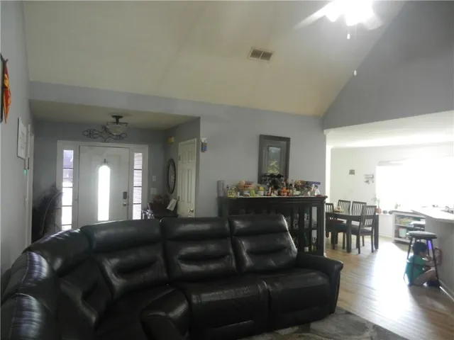 a living room with furniture and wooden floor