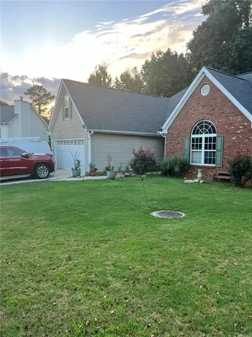 a front view of house with yard and green space