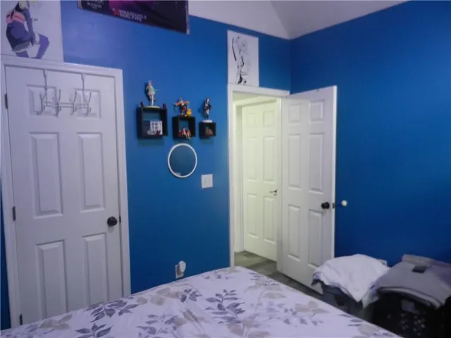 a bedroom with a bed and a chandelier