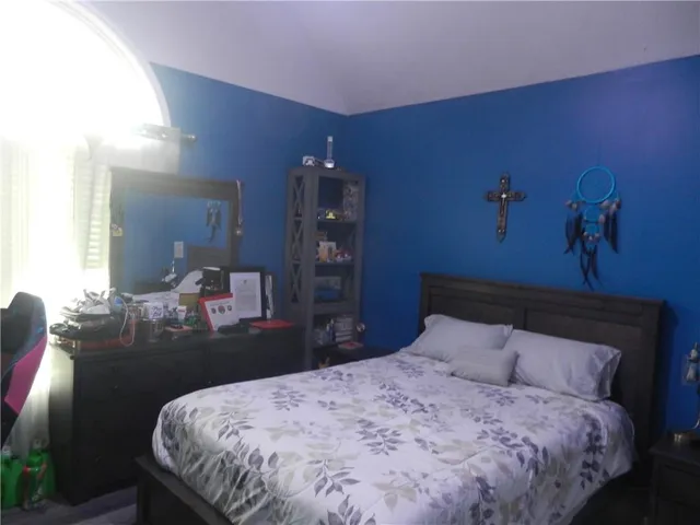 a bedroom with bed and window