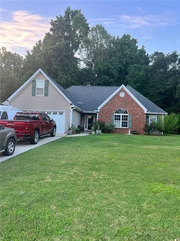 a front view of a house with garden