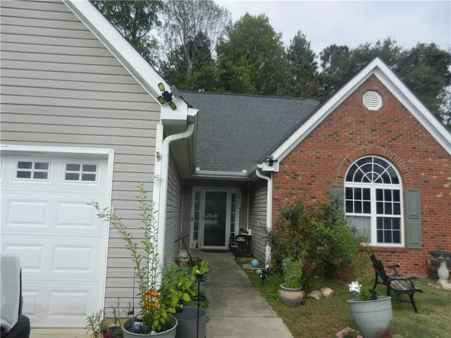 a front view of a house with garden