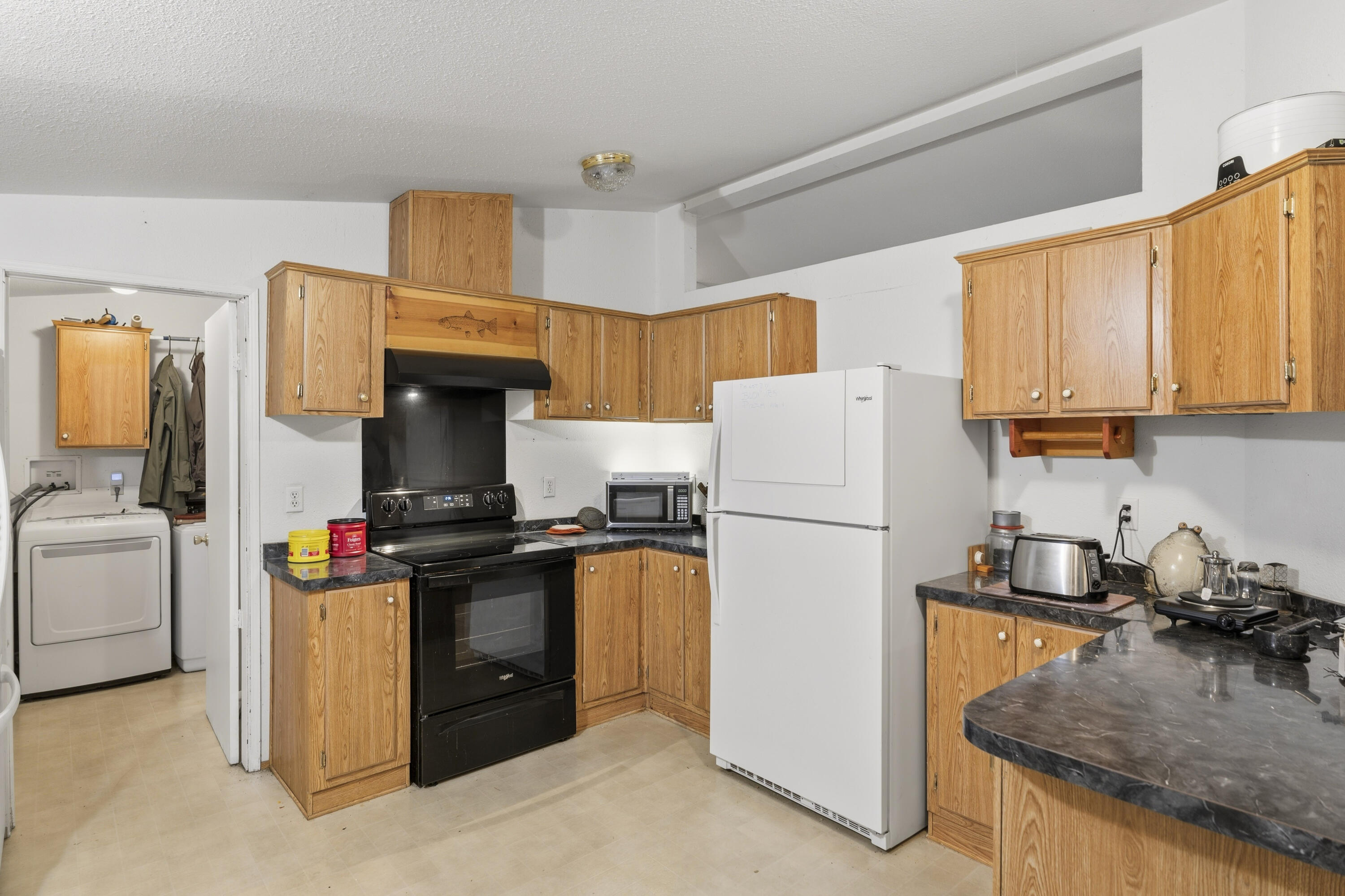 16928 Covina Road Bend, OR 97707 - Photo 15 of 48 a kitchen with a stove a refrigerator and a sink