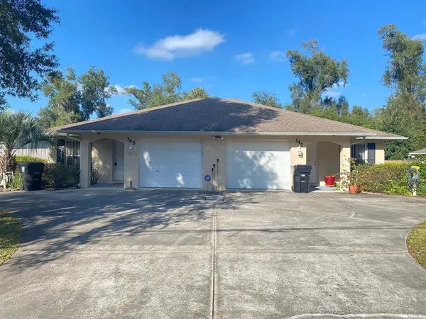 a view of a house with a yard and garage