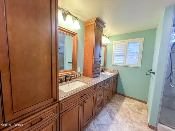 a view of a kitchen with a sink and wooden floor