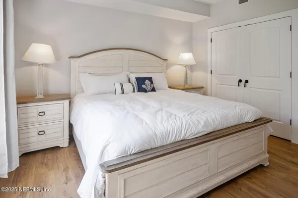 a bedroom with a bed and a lamp