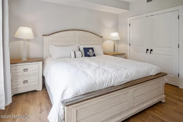 a bedroom with a bed and a lamp